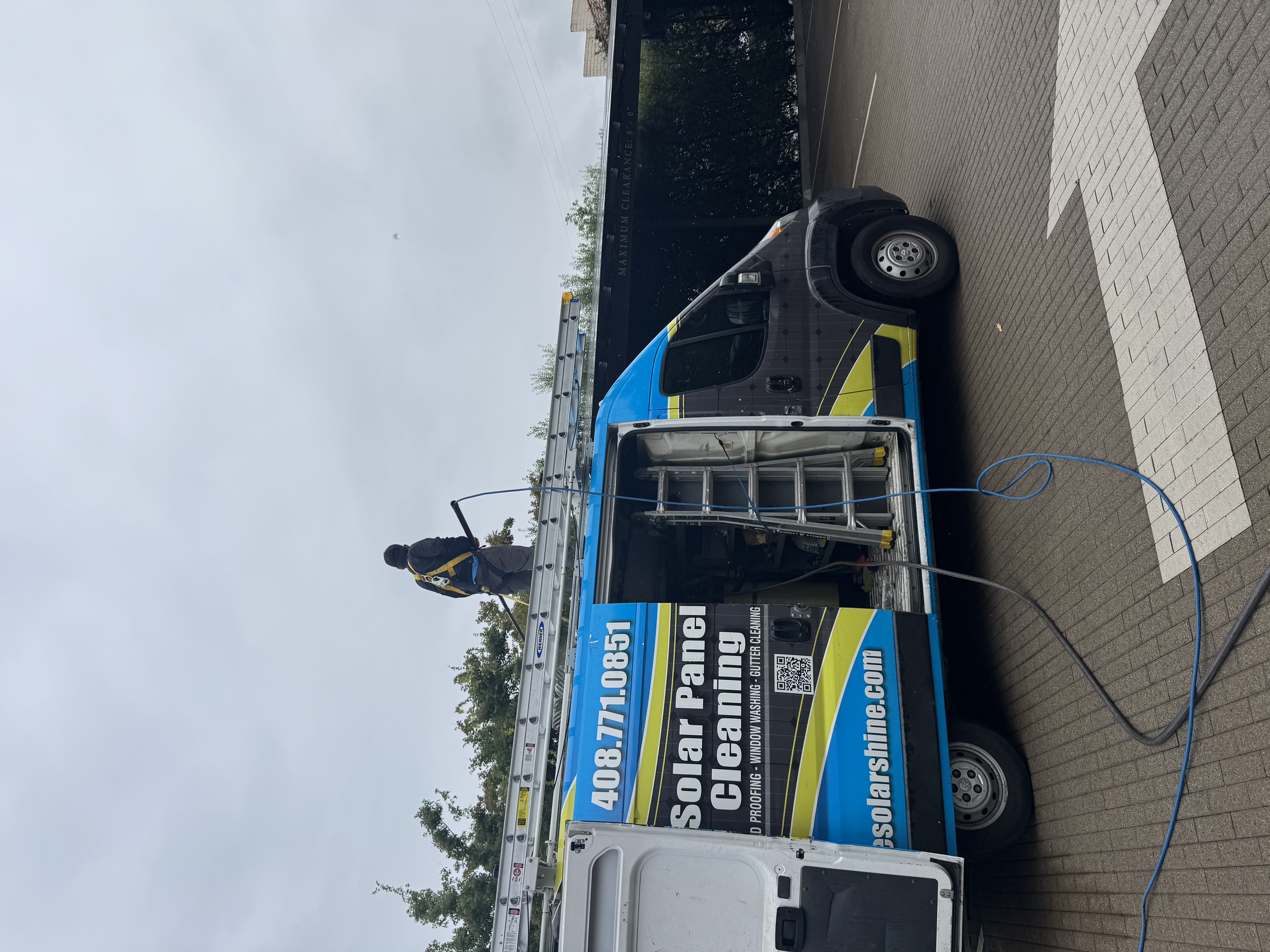 All One Solar Shine technician cleaning a rooftop
